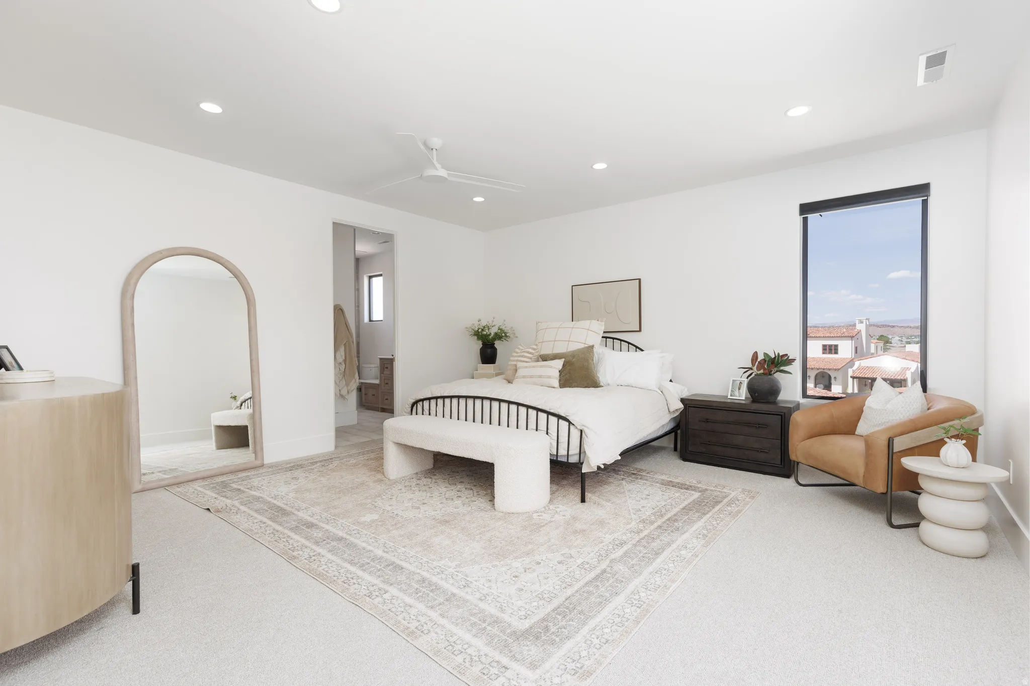 Bedroom featuring a ceiling fan, multiple windows, light carpet, recessed lighting, and connected bathroom