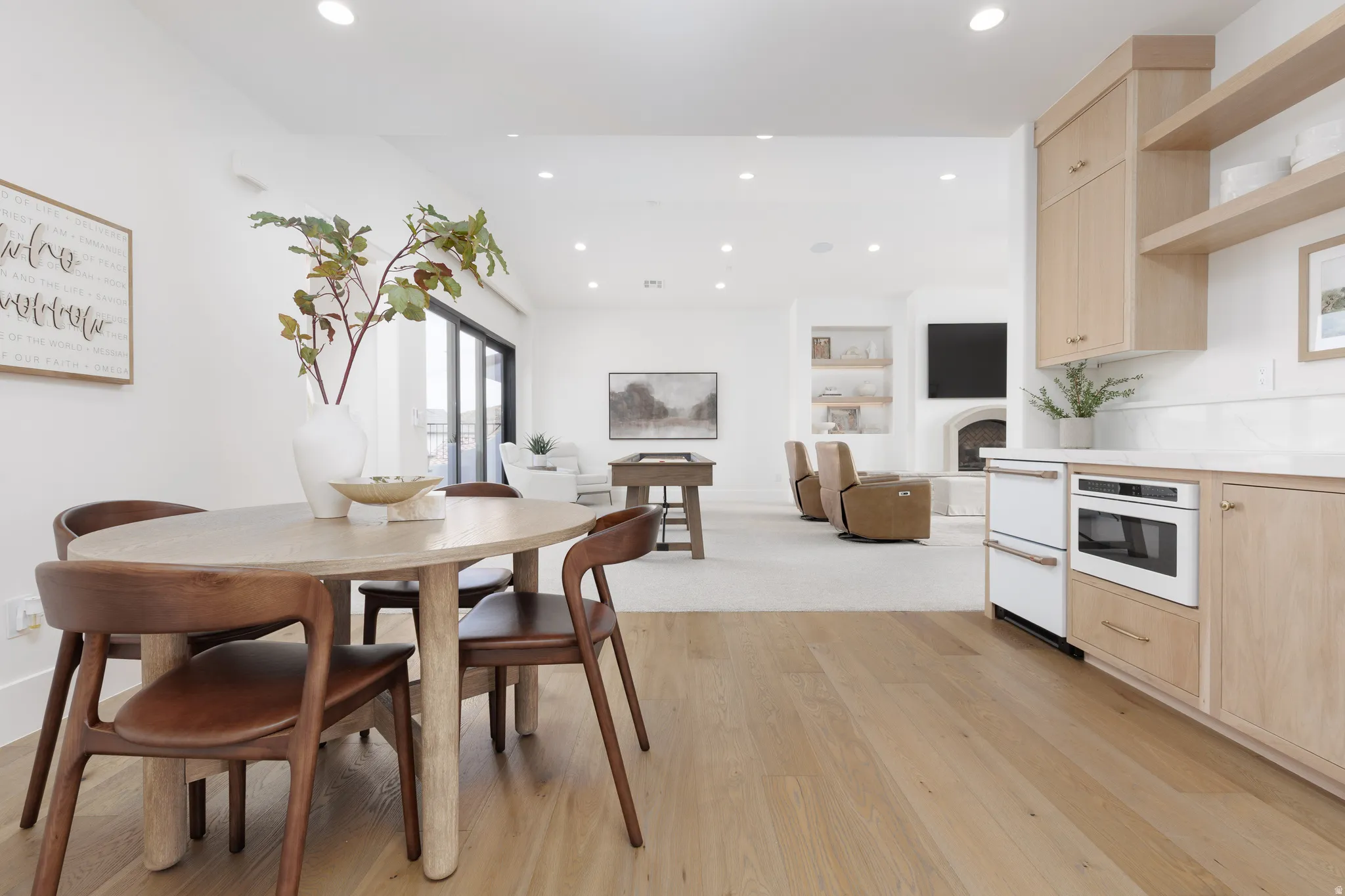 Dining space featuring light wood-style flooring, vaulted ceiling, and recessed lighting