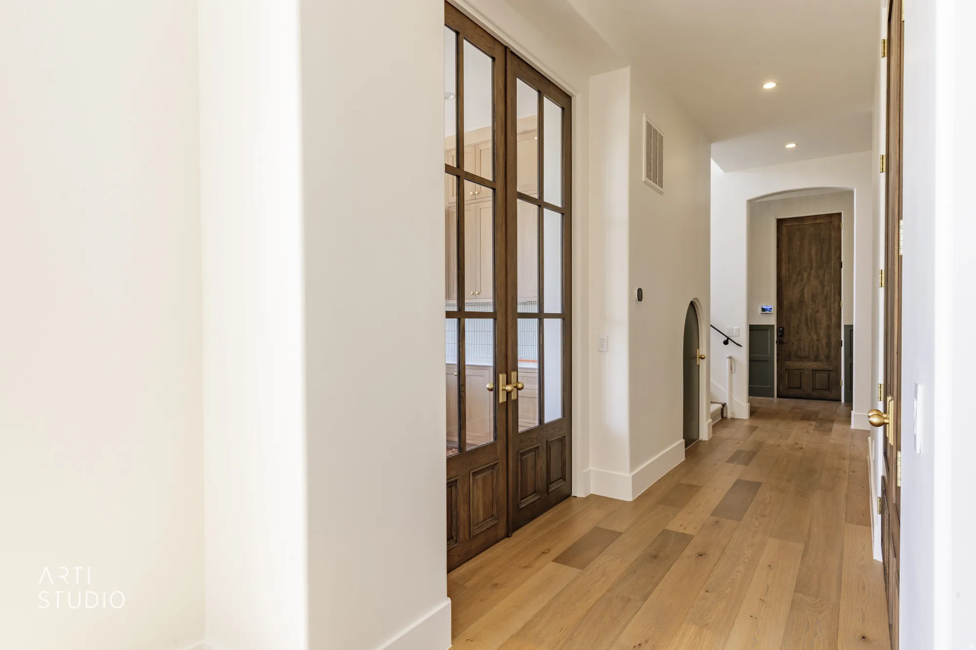 Hallway featuring light wood-finish flooring, white baseboards, and recessed lighting