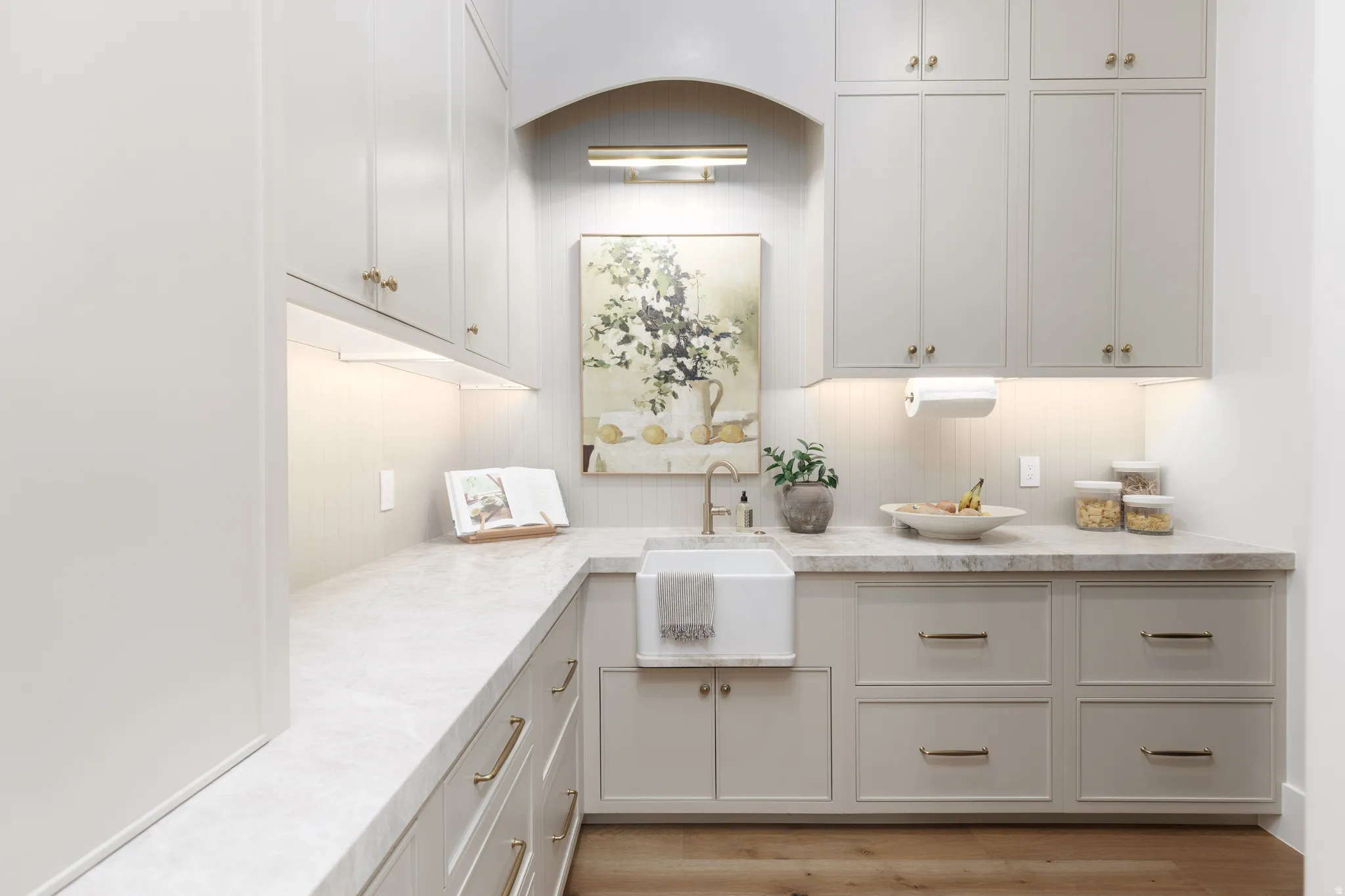 Kitchen featuring light wood-style floors and white cabinets