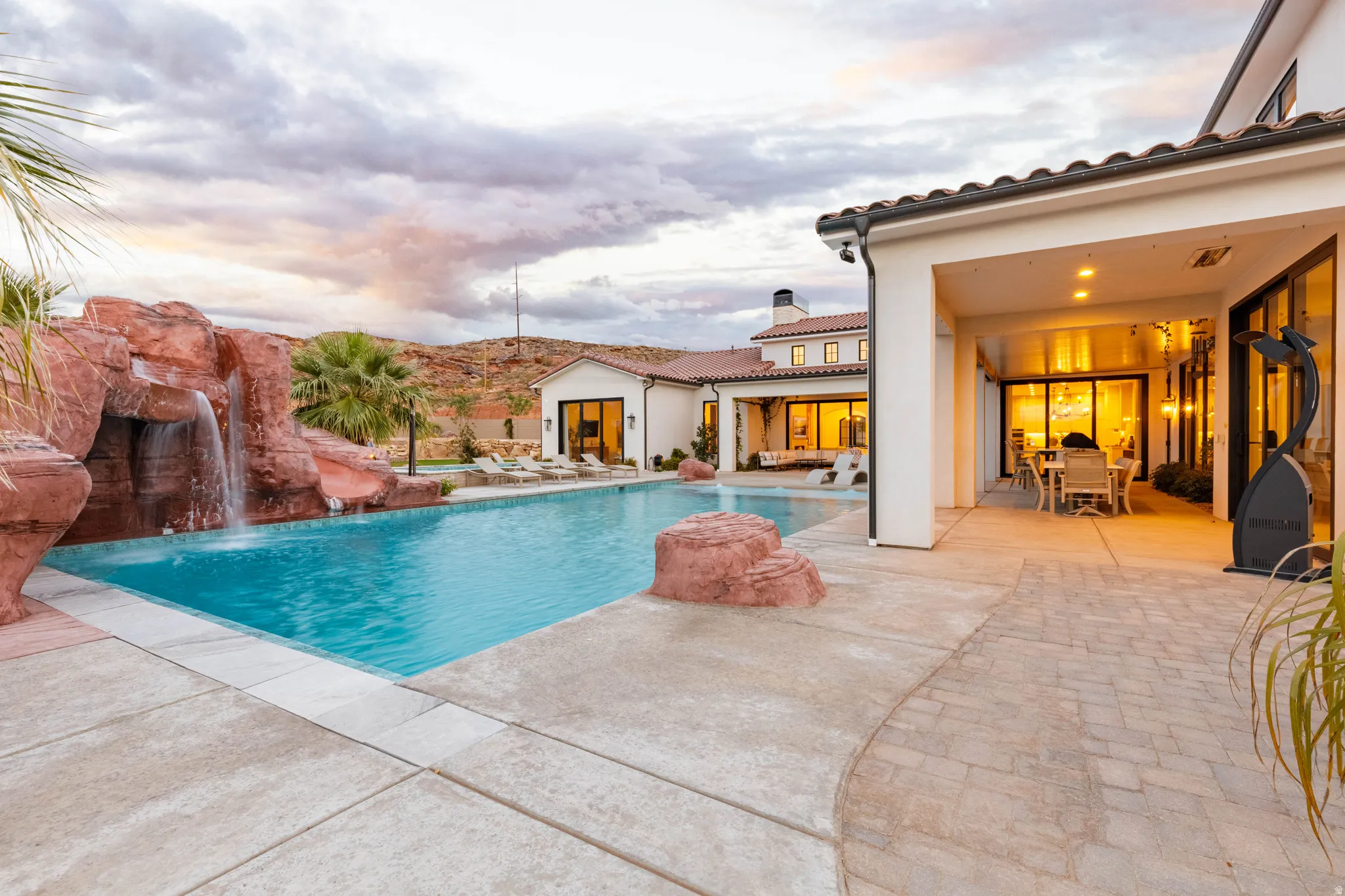 Outdoor pool with a patio and outdoor dining area