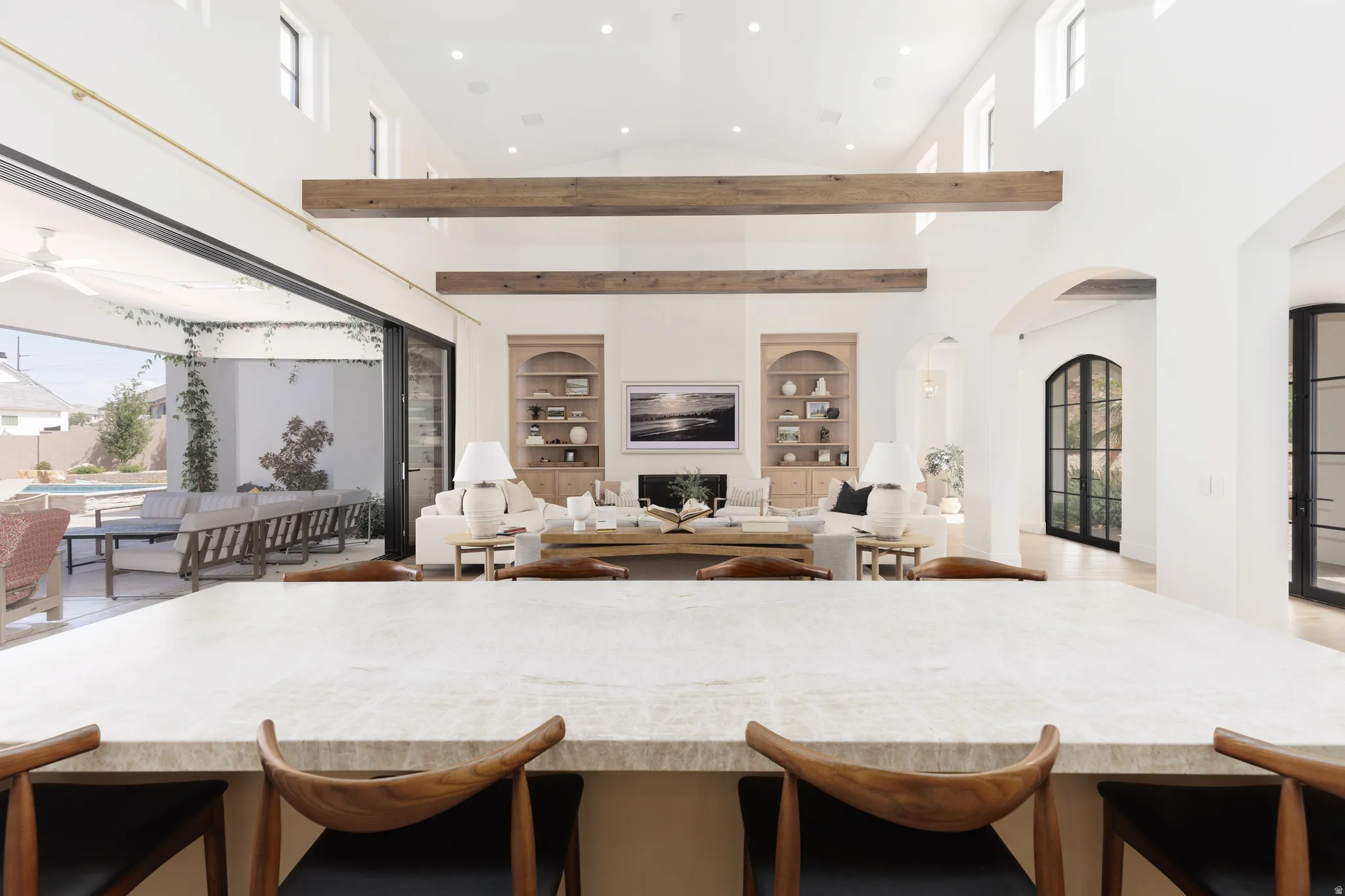 Kitchen with recessed lighting, built in shelves, open floor plan, arched walkways, and lofted ceiling