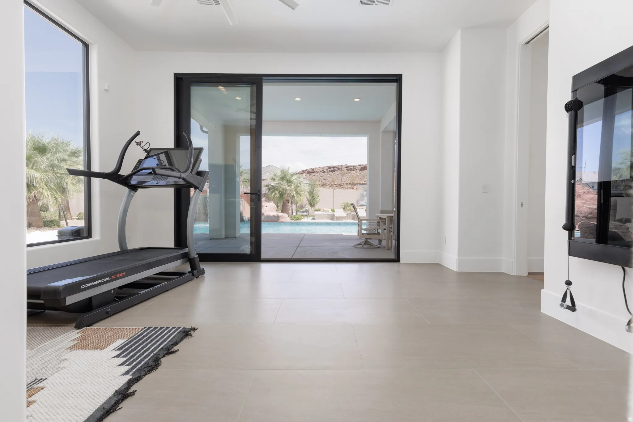 Exercise area with baseboards and recessed lighting