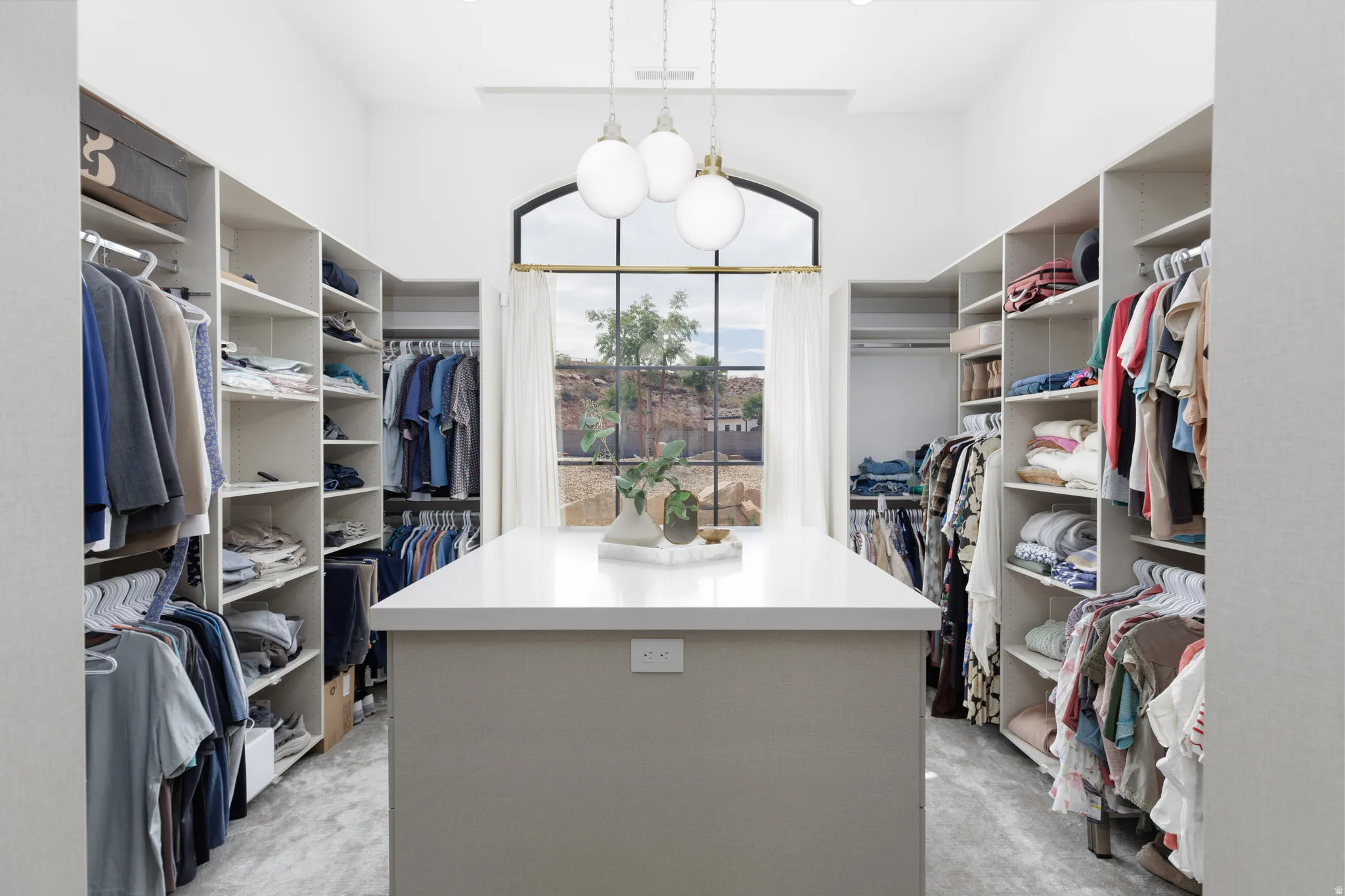 Walk in closet featuring light carpet