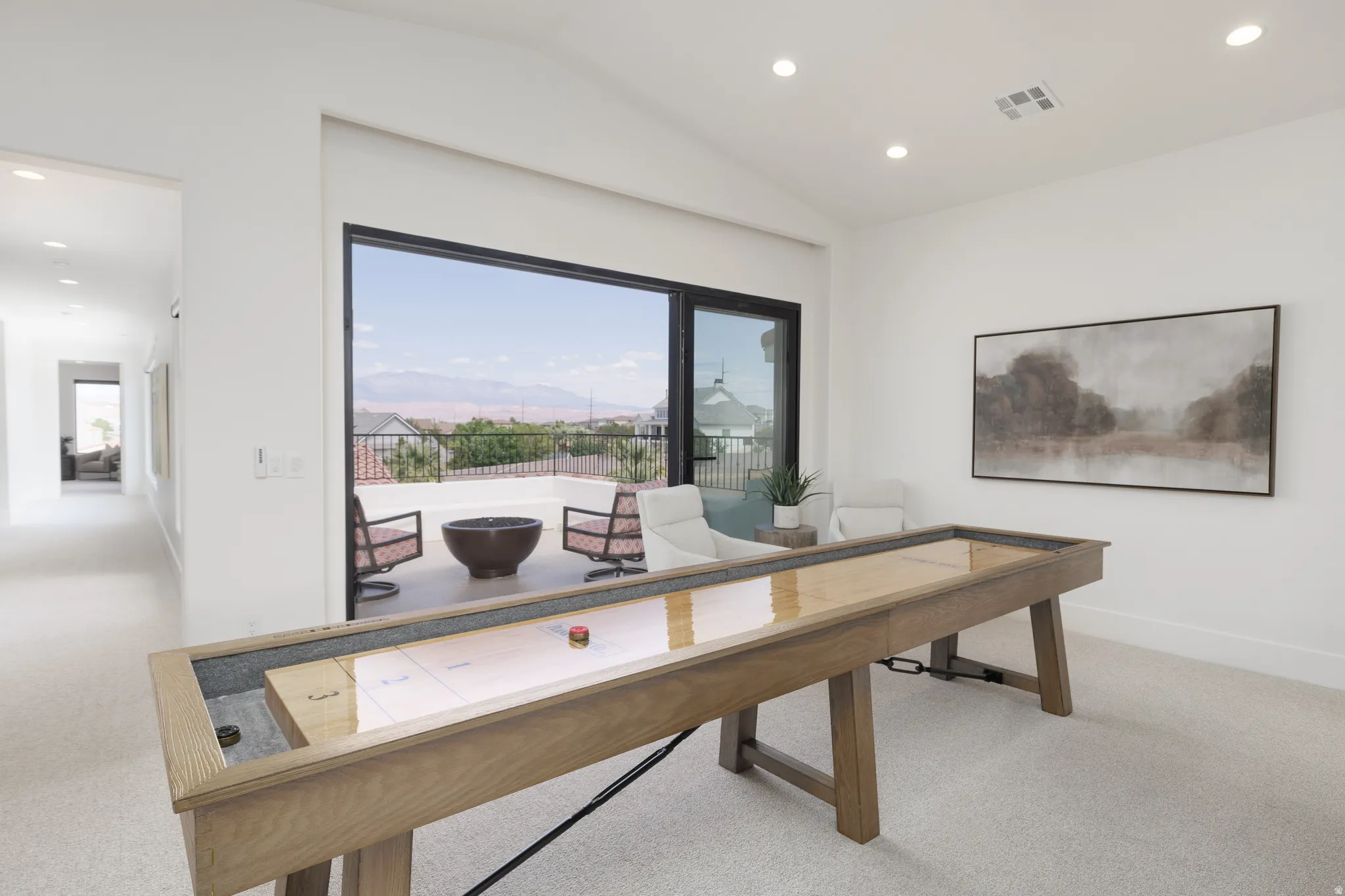 Game room with recessed lighting, a mountain view, light carpet, and vaulted ceiling