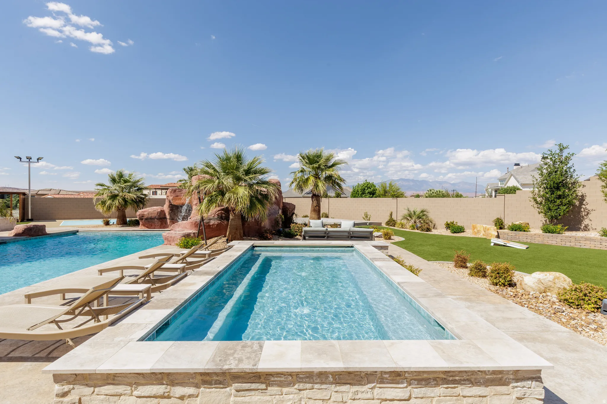 View of swimming pool featuring patio surround, a fenced backyard, and an outdoor lounge area