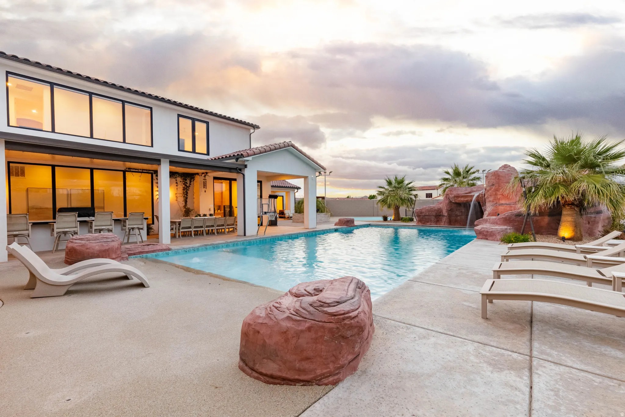 Swimming pool with a patio and outdoor dining area