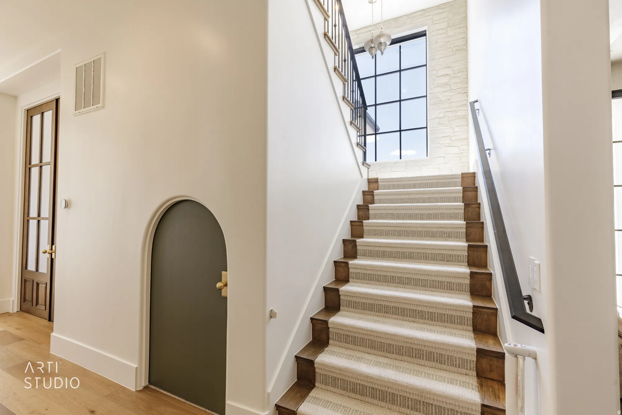 Staircase with wood treads and a striped runner