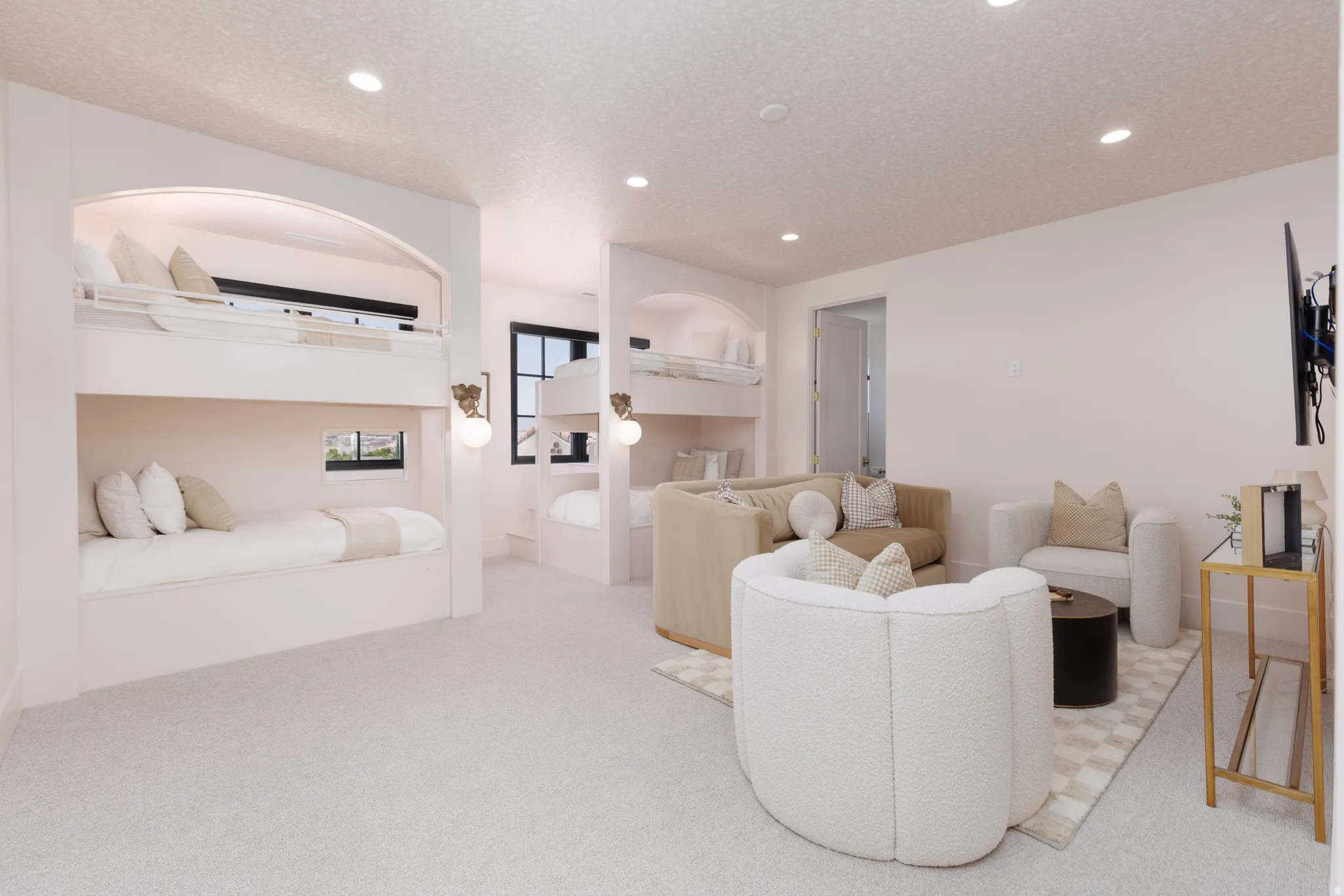 Living area with light colored carpet, a textured ceiling, and recessed lighting