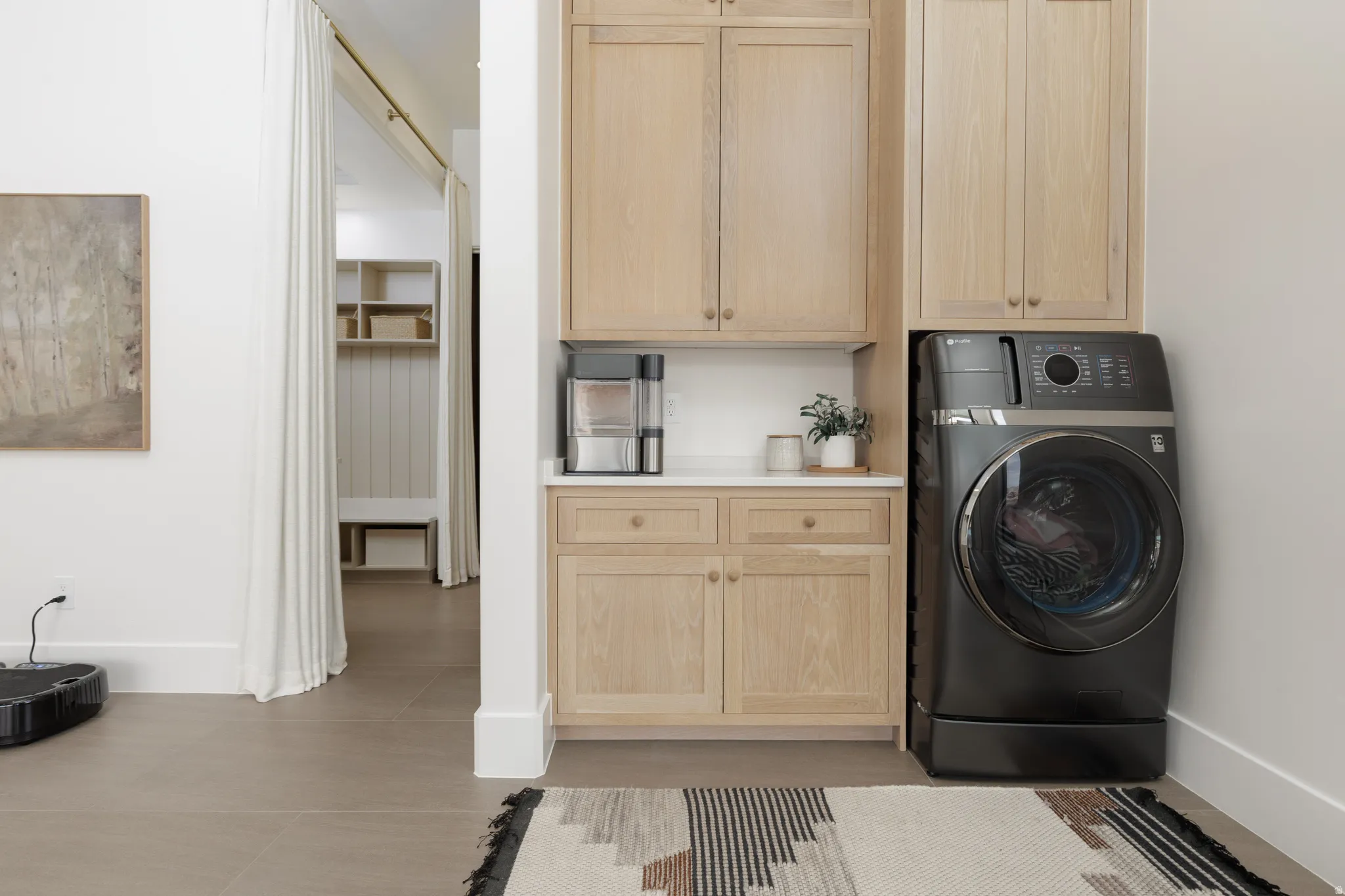 Laundry room featuring washer / dryer and cabinet space