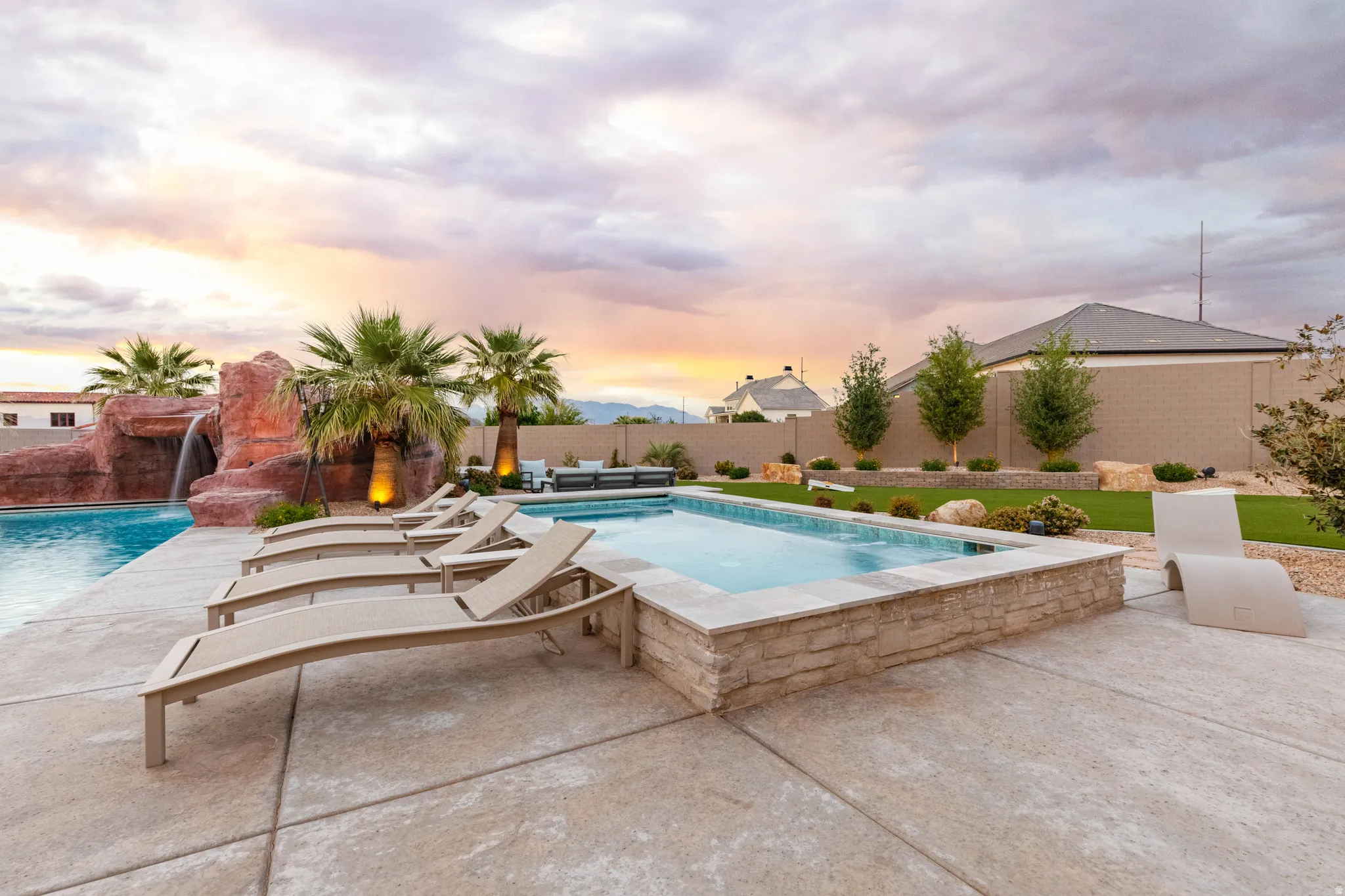 Pool at dusk featuring a patio and a fenced backyard