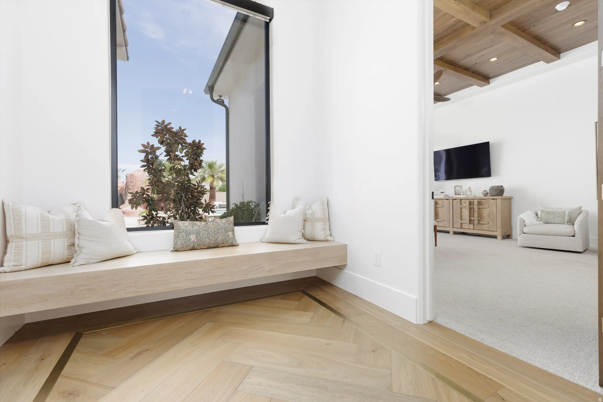 Sitting room featuring parquet floors, recessed lighting, and a wooden ceiling with exposed beams