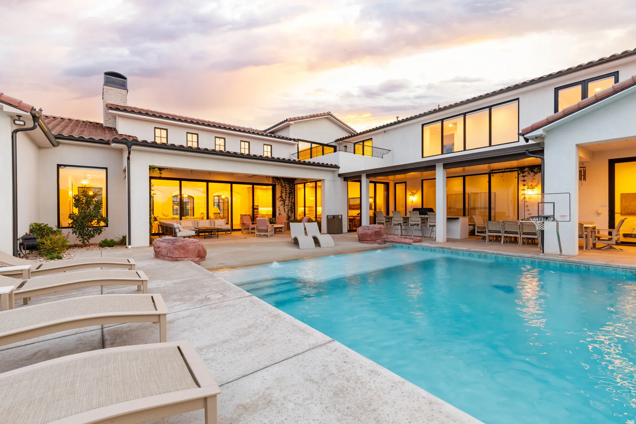 Rear view of house featuring a patio area, an outdoor pool, a tile roof, a chimney, and an outdoor kitchen