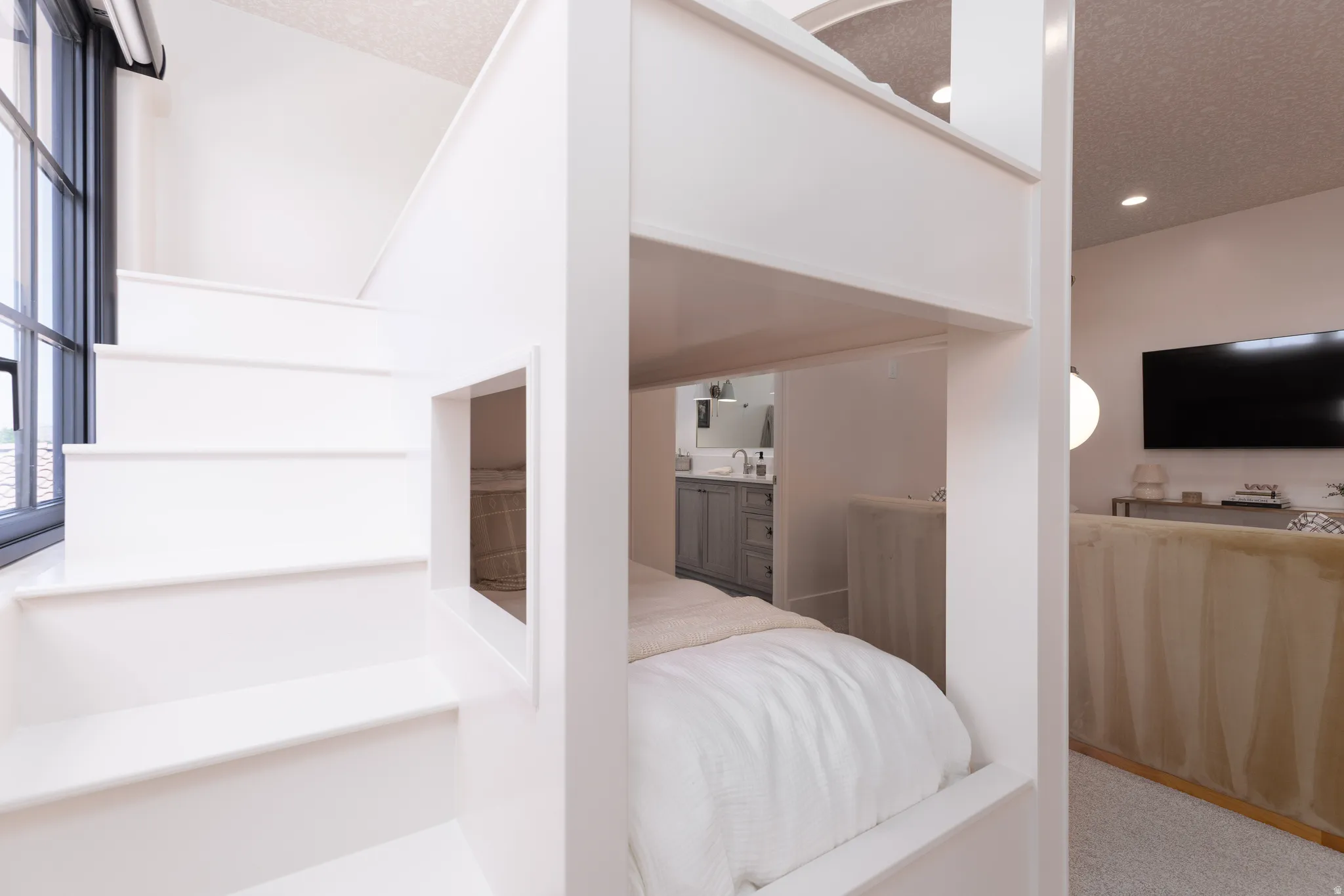 Bedroom featuring a textured ceiling and light carpet