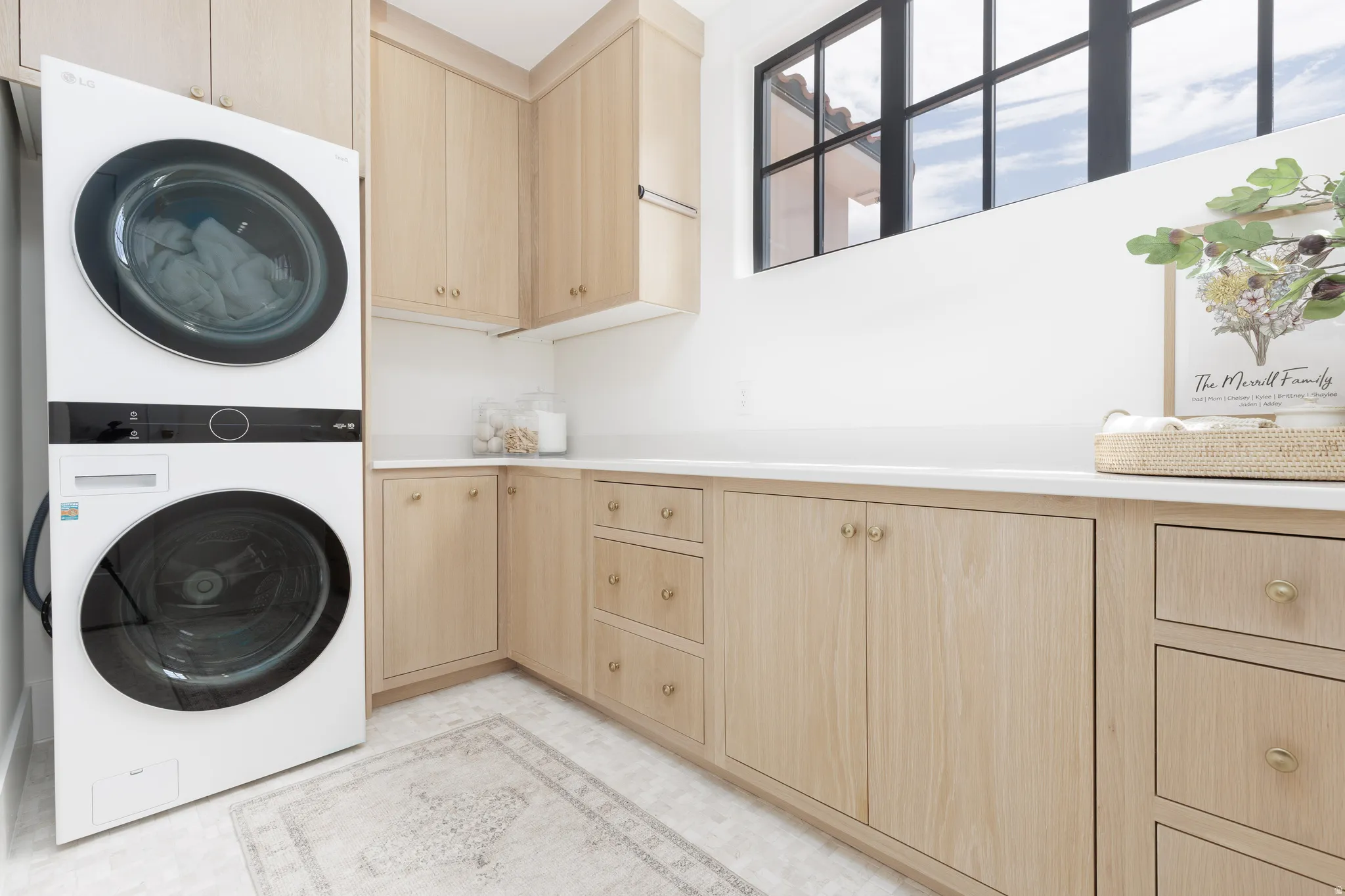 Laundry room with stacked washer / drying machine and cabinet space
