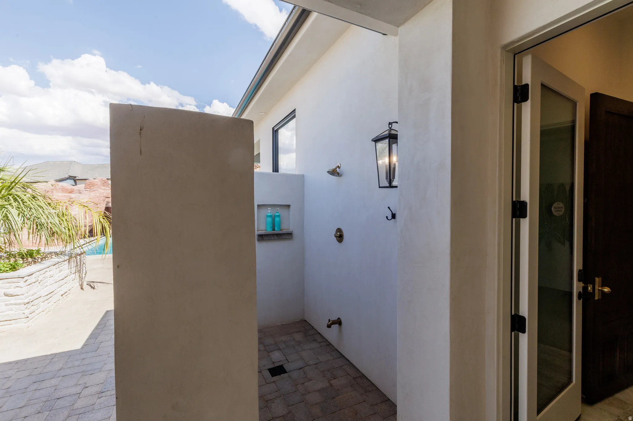 View of home's exterior with stucco siding and a patio area