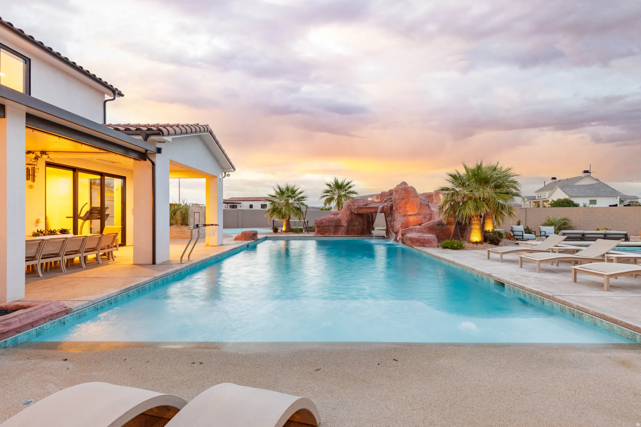 View of swimming pool featuring patio surround, a fenced backyard, and a pergola