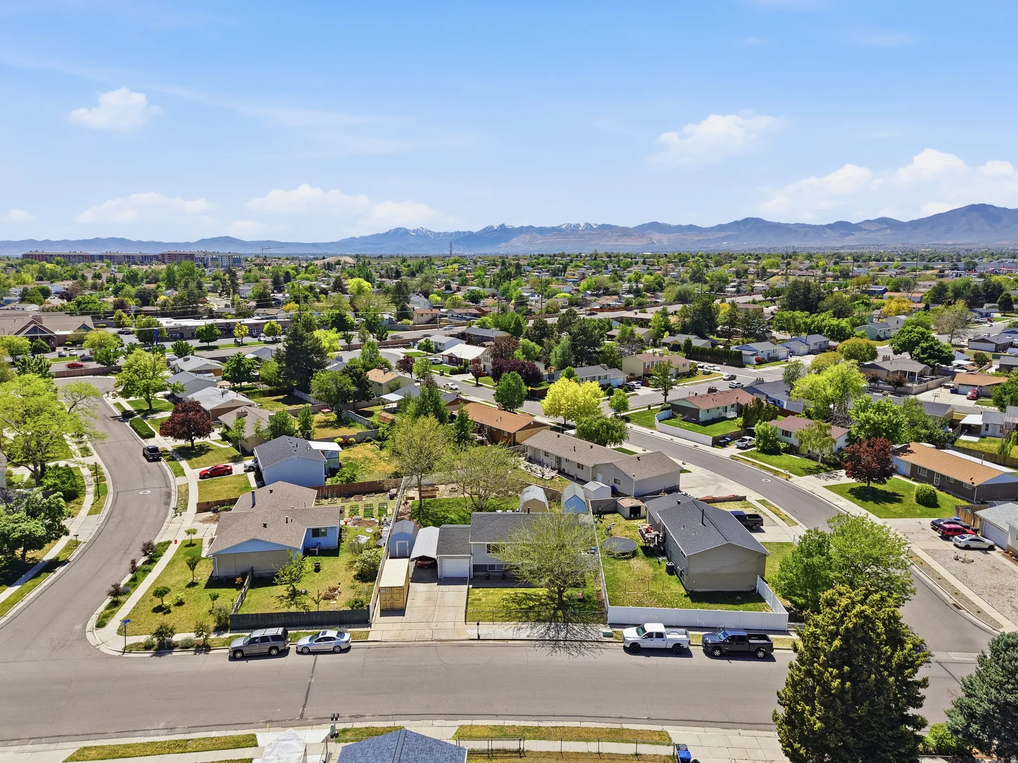 Expansive residential neighborhood featuring numerous single-story homes with pitched roofs, mature trees, and individual yards