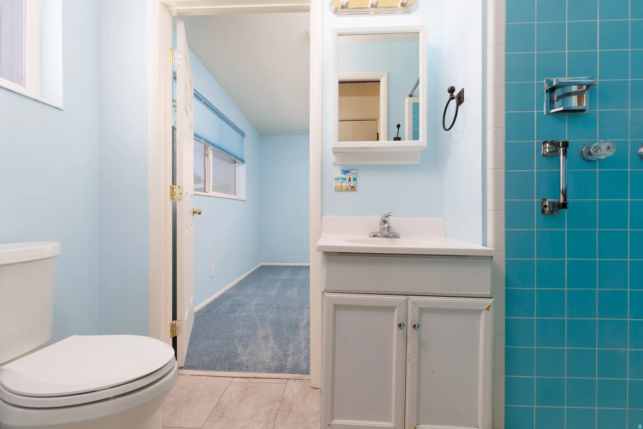 Primary Bathroom with white vanity, integrated sink, and medicine cabinet