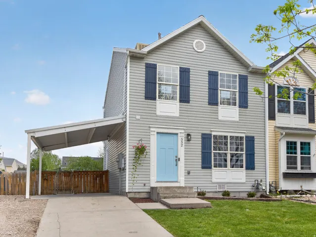 Light gray siding exterior with blue shutters and a light blue front door