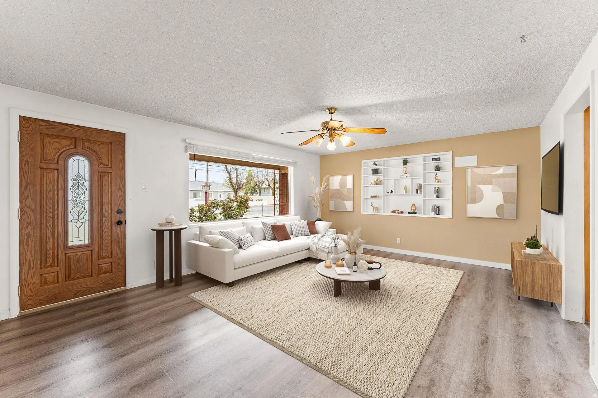 *Virtually Staged* Living room featuring ceiling fan, wood finished floors, and a textured ceiling