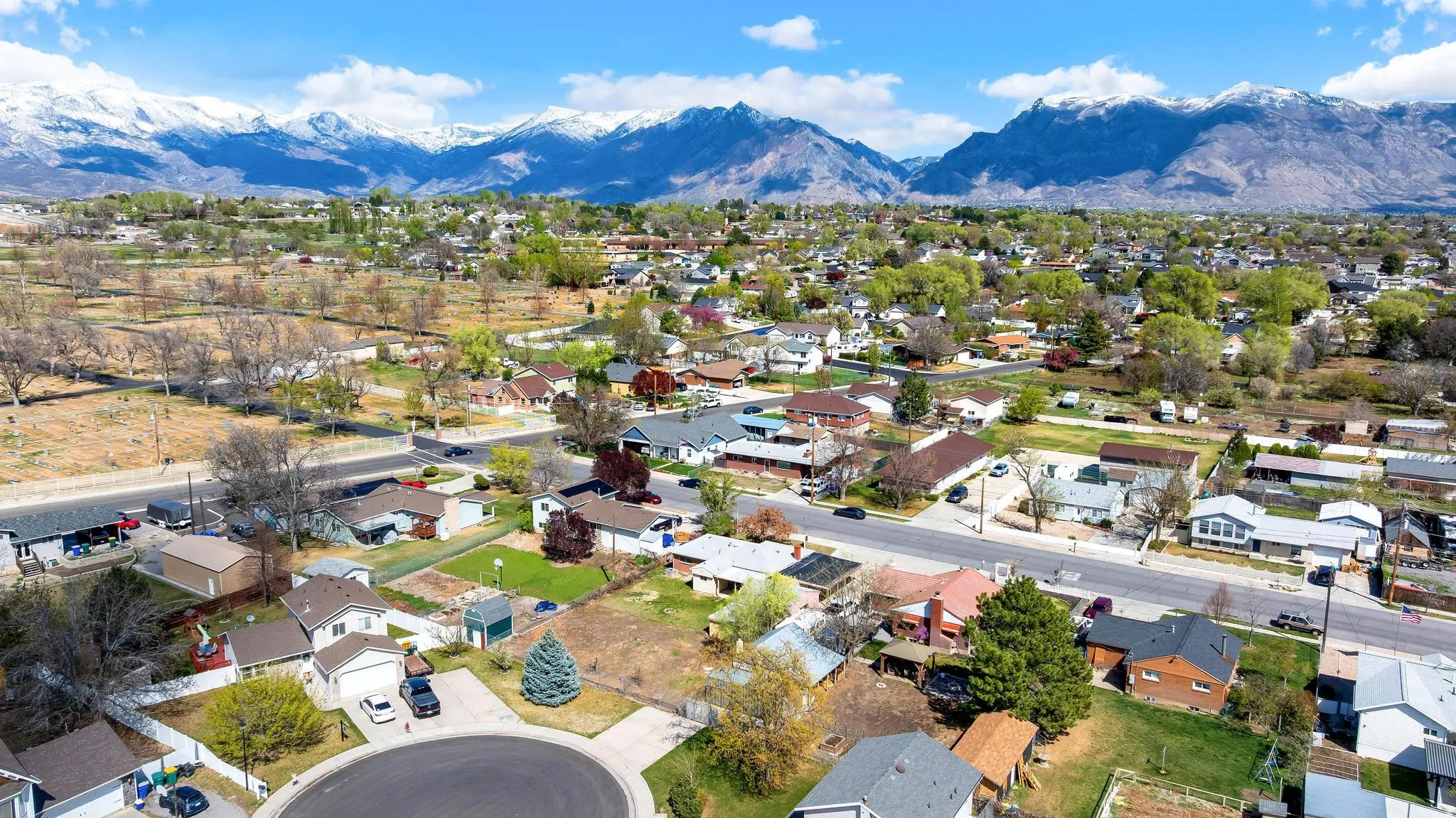 Aerial perspective of suburban area featuring a mountain backdrop