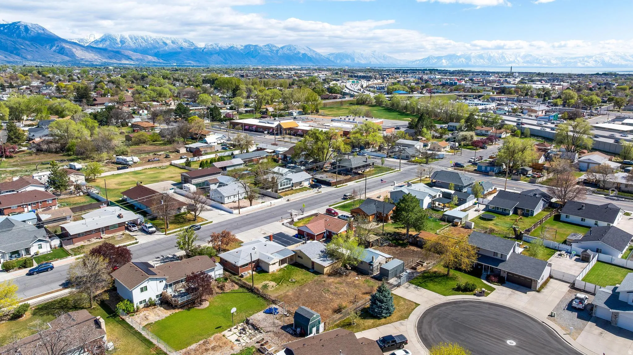 Aerial perspective of suburban area featuring a mountainous background