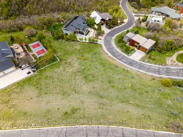 Expansive grassy lot featuring a gentle slope