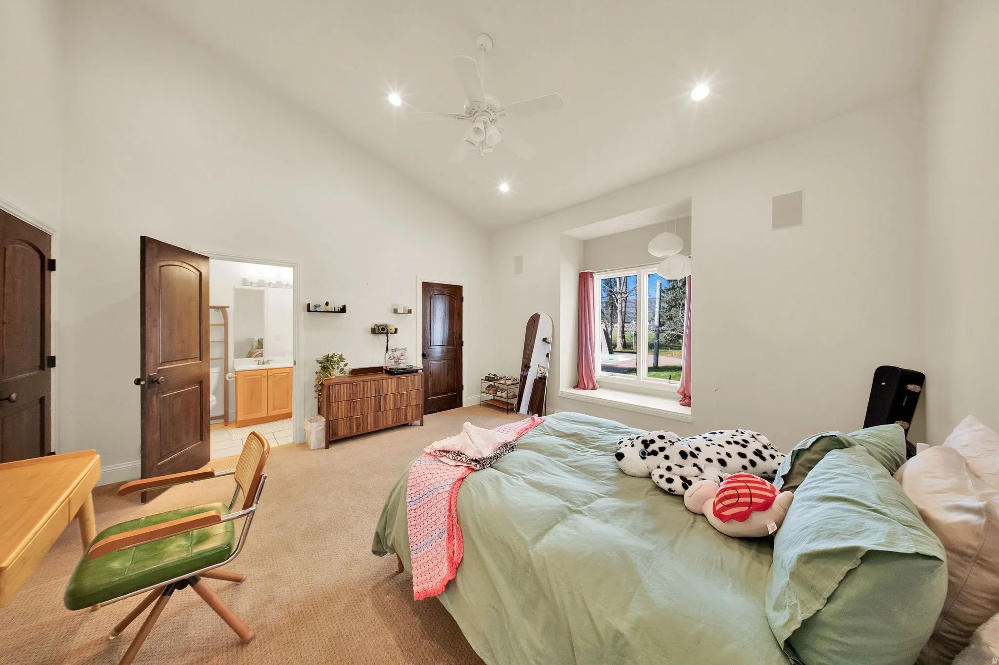 Vaulted ceiling bedroom featuring plush carpeting, recessed lighting, and a ceiling fan