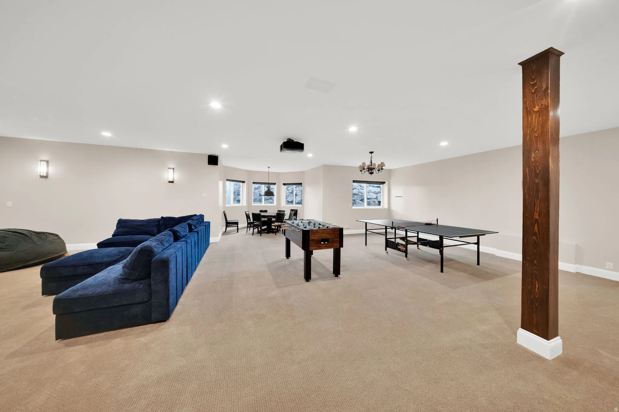 Spacious recreation room featuring neutral carpeting and recessed lighting