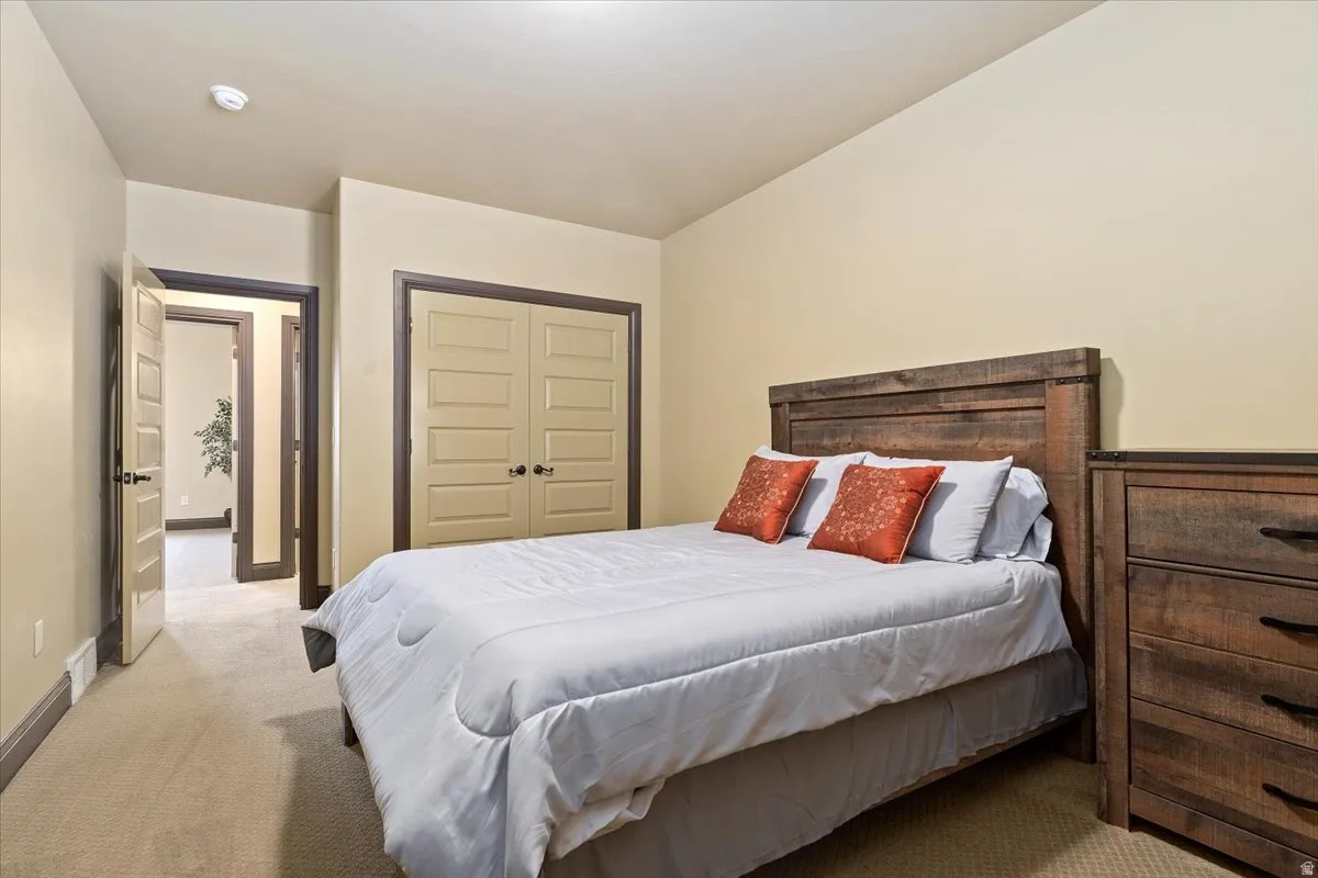 Carpeted room with neutral walls, trim, and baseboards