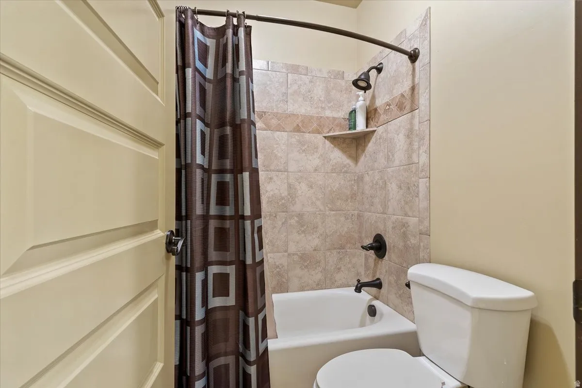 Full bathroom featuring a tub/shower combination with tiled surround, an integrated corner shelf, and oil-rubbed bronze fixtures