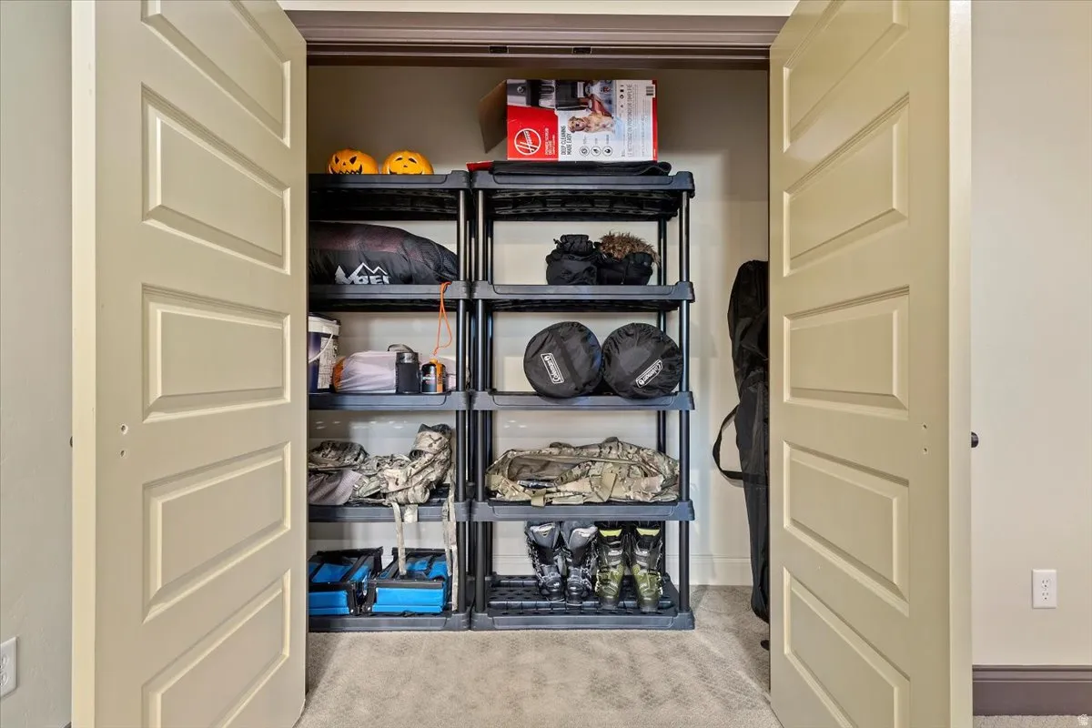 Spacious closet featuring two bi-fold panel doors, neutral carpeting, and light-colored walls