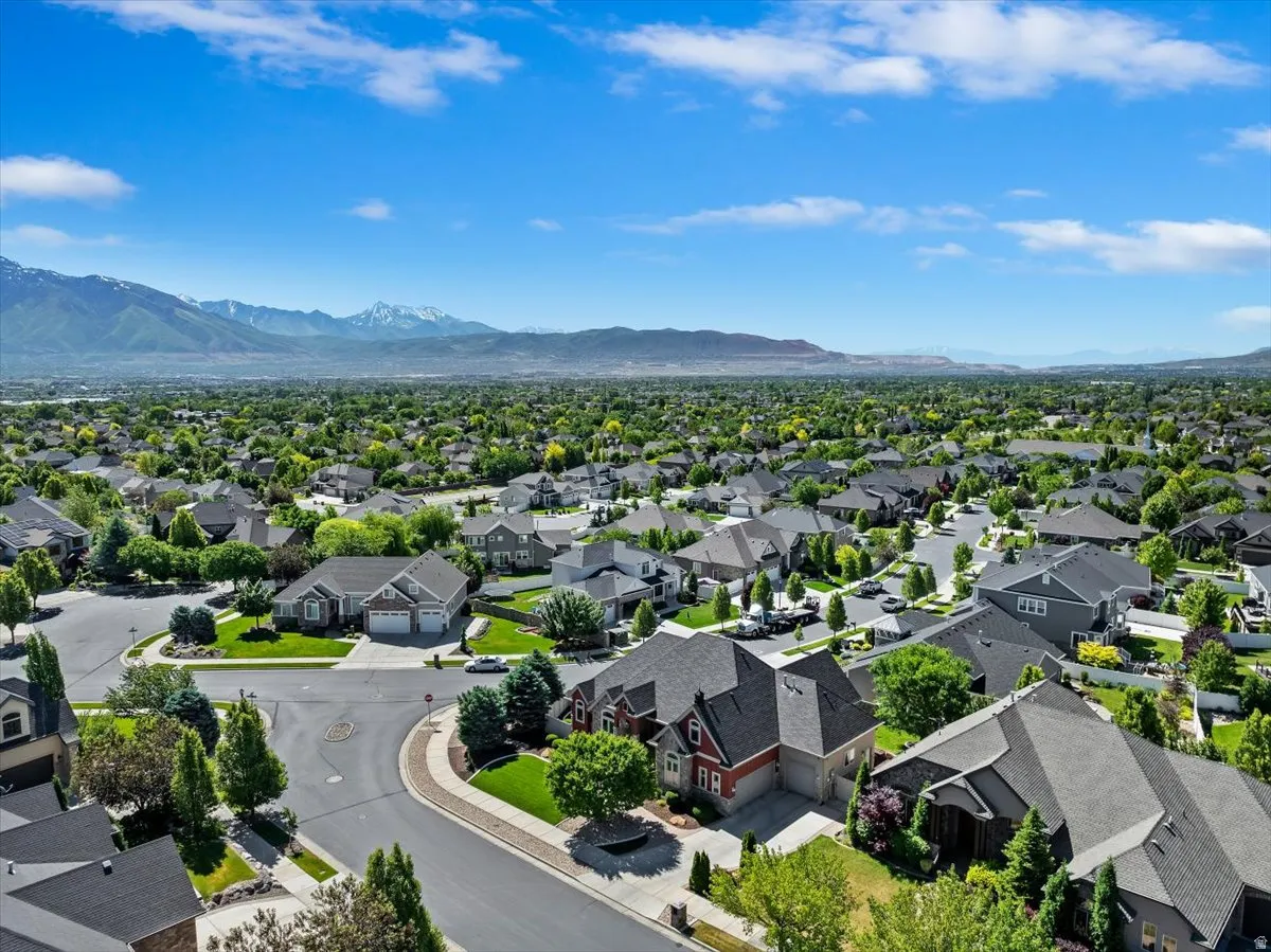 Expansive residential neighborhood with mature trees and mountain backdrops