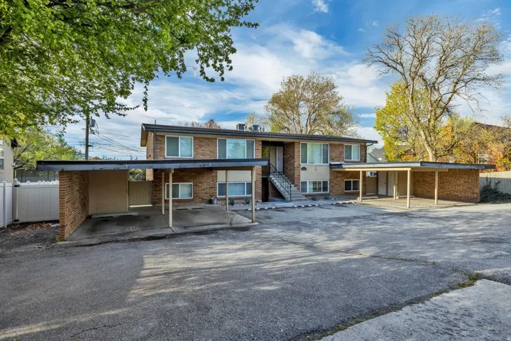 Brick exterior multi-unit building featuring upper and lower level units