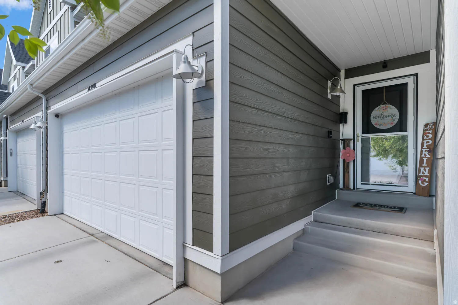 Entryway featuring horizontal siding, a white storm door, and a concrete porch with steps