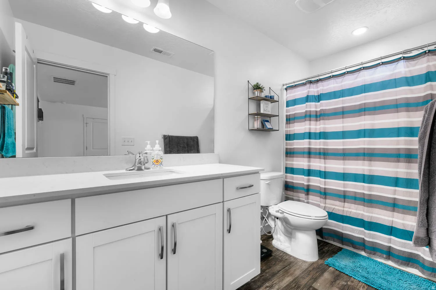 White vanity featuring a built-in sink and ample storage cabinetry