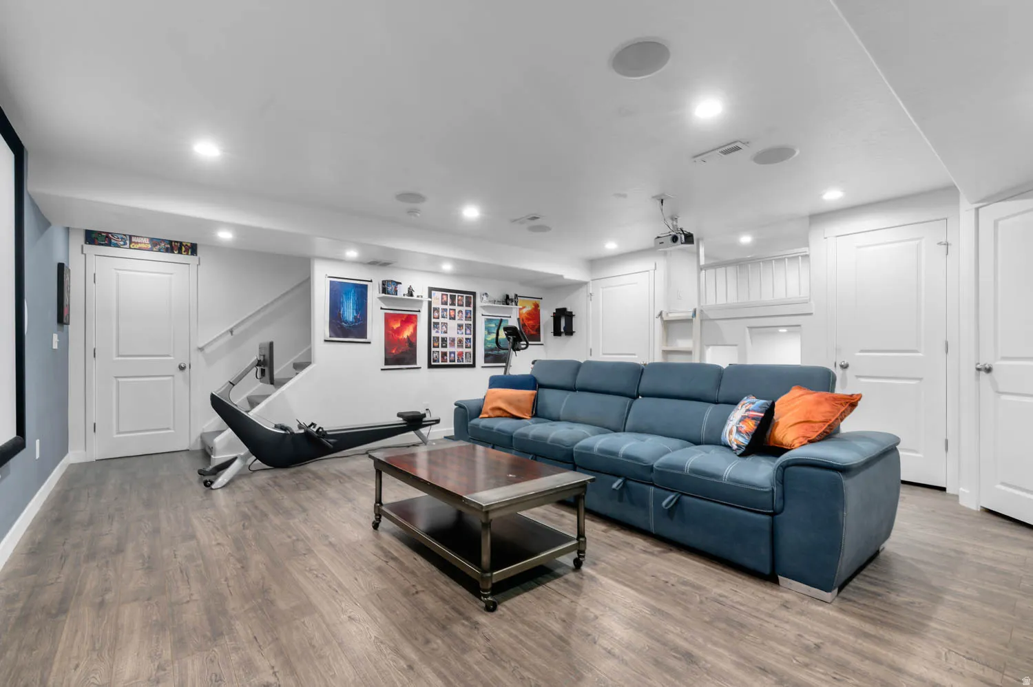 Spacious area featuring wood-finish flooring, recessed lighting, and white trim