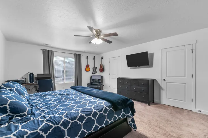 Bedroom featuring light-colored walls and carpet flooring
