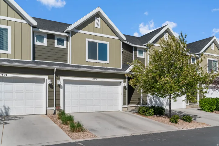 Contemporary townhome exterior with mixed siding, featuring vertical board and batten accents