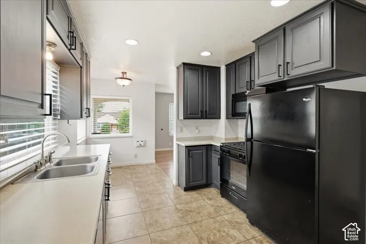 Kitchen featuring dark cabinetry, light countertops, and tile flooring