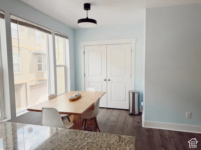 Expansive windows, wood-finish flooring, and a modern ceiling light fixture