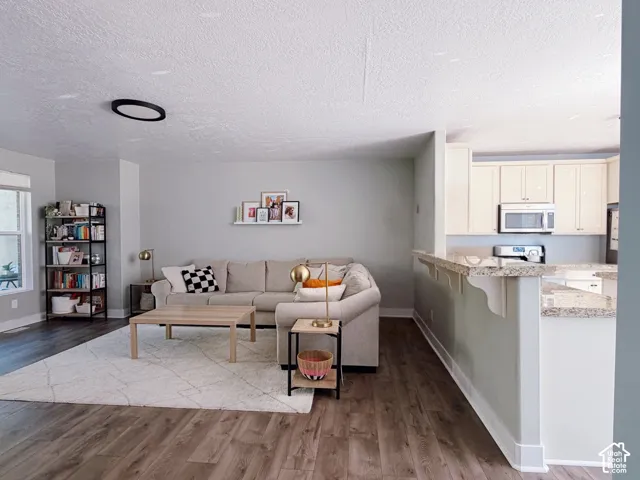 Wood-finish flooring throughout, light gray wall tones, and recessed ceiling lighting