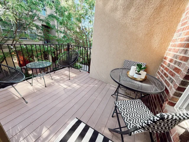 Outdoor balcony featuring wood-finish decking