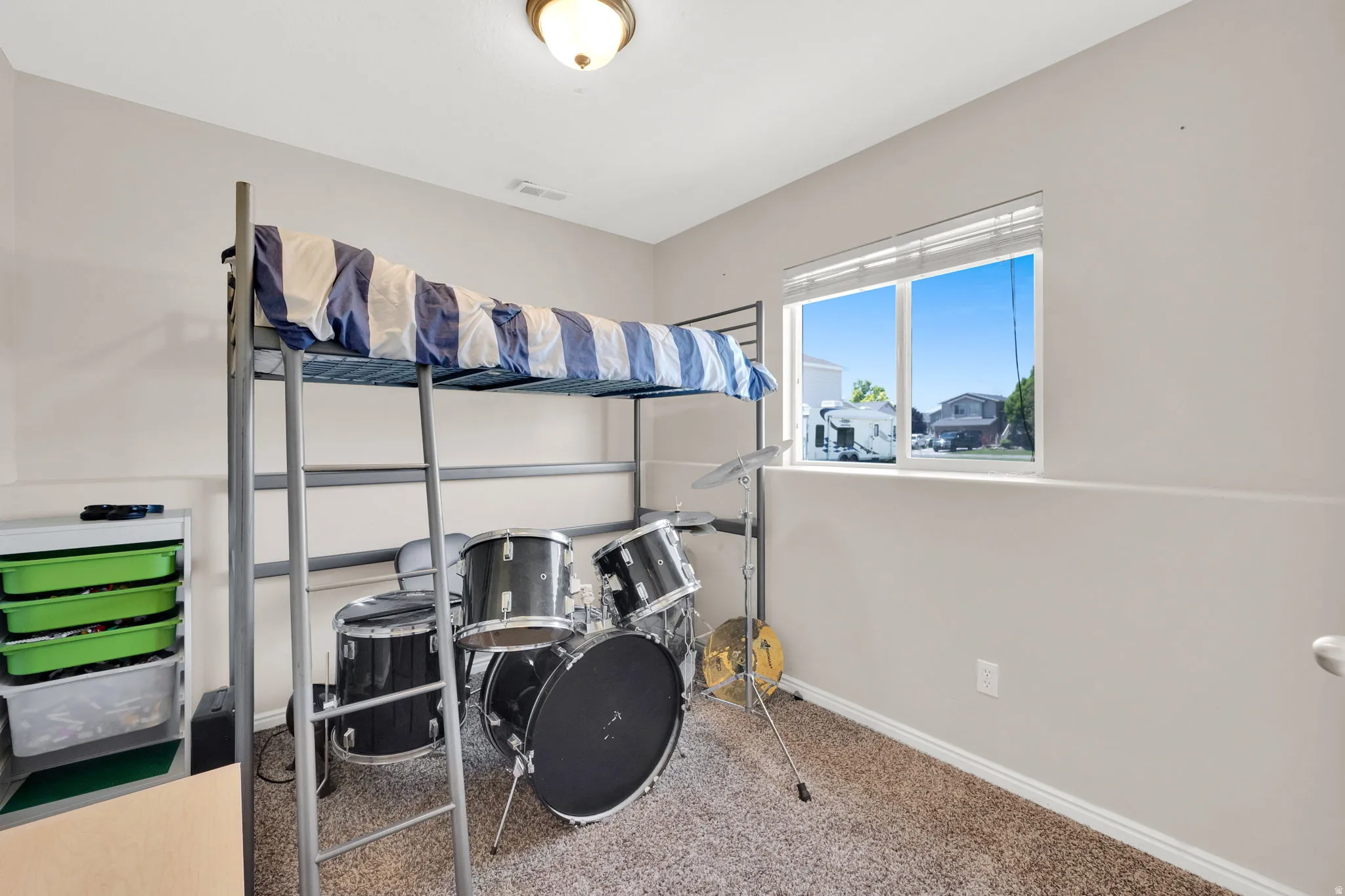 Carpeted room with a double-pane window and neutral wall paint