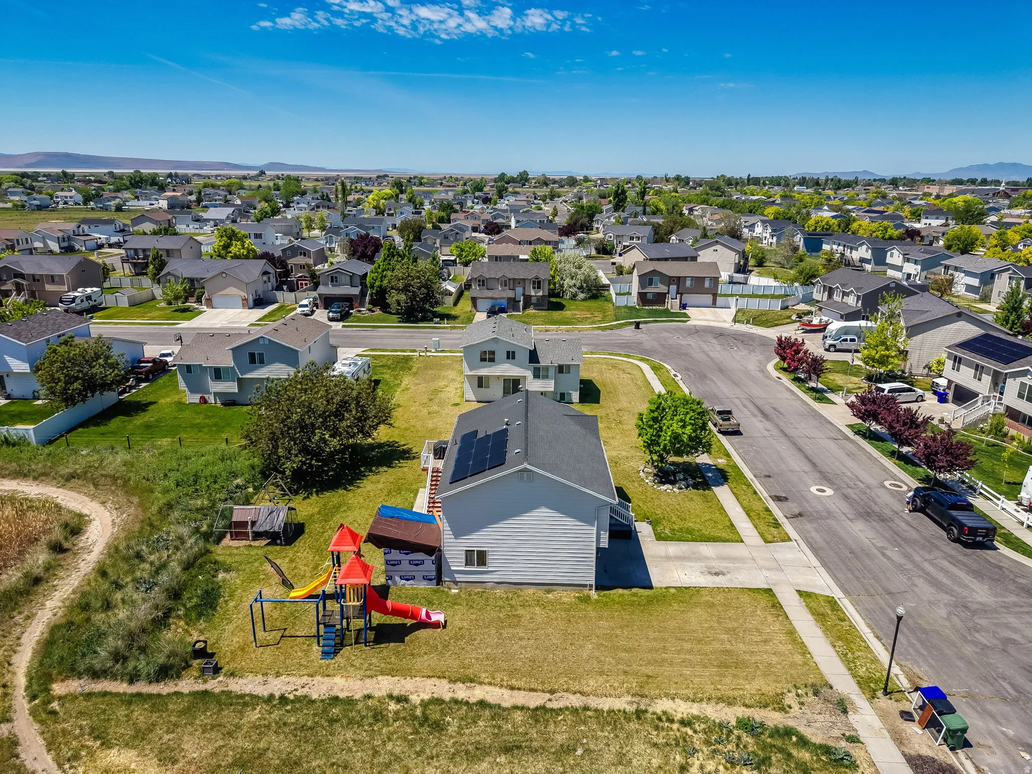 Residential neighborhood featuring a mix of single-story and two-story homes, established landscaping, and paved streets