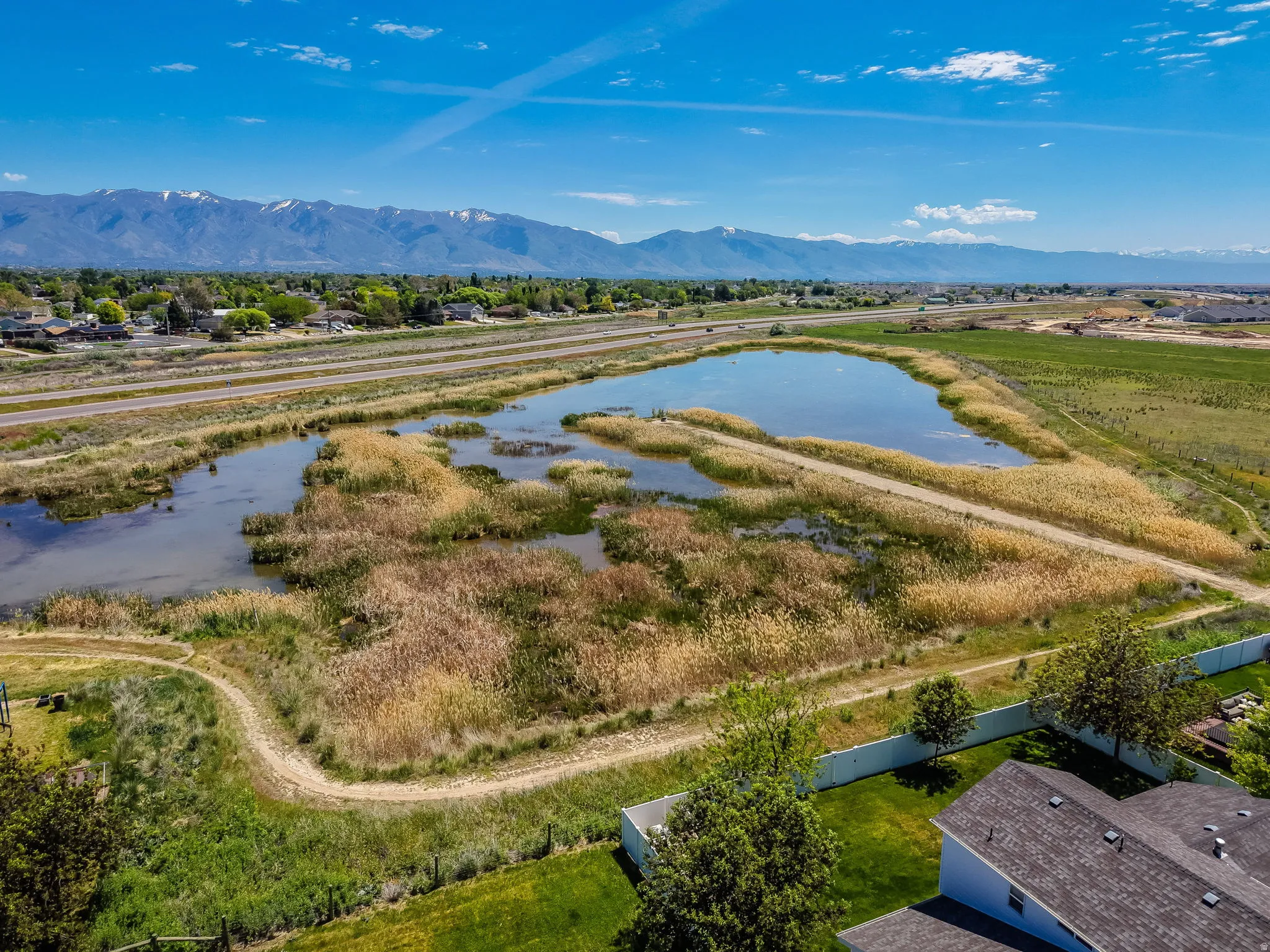 Expansive wetlands area featuring a reflective pond and natural reeds
