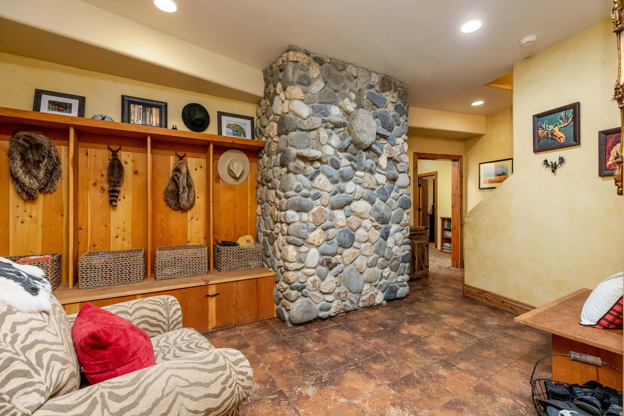 River rock stone column accenting an entry area with wood-finish flooring