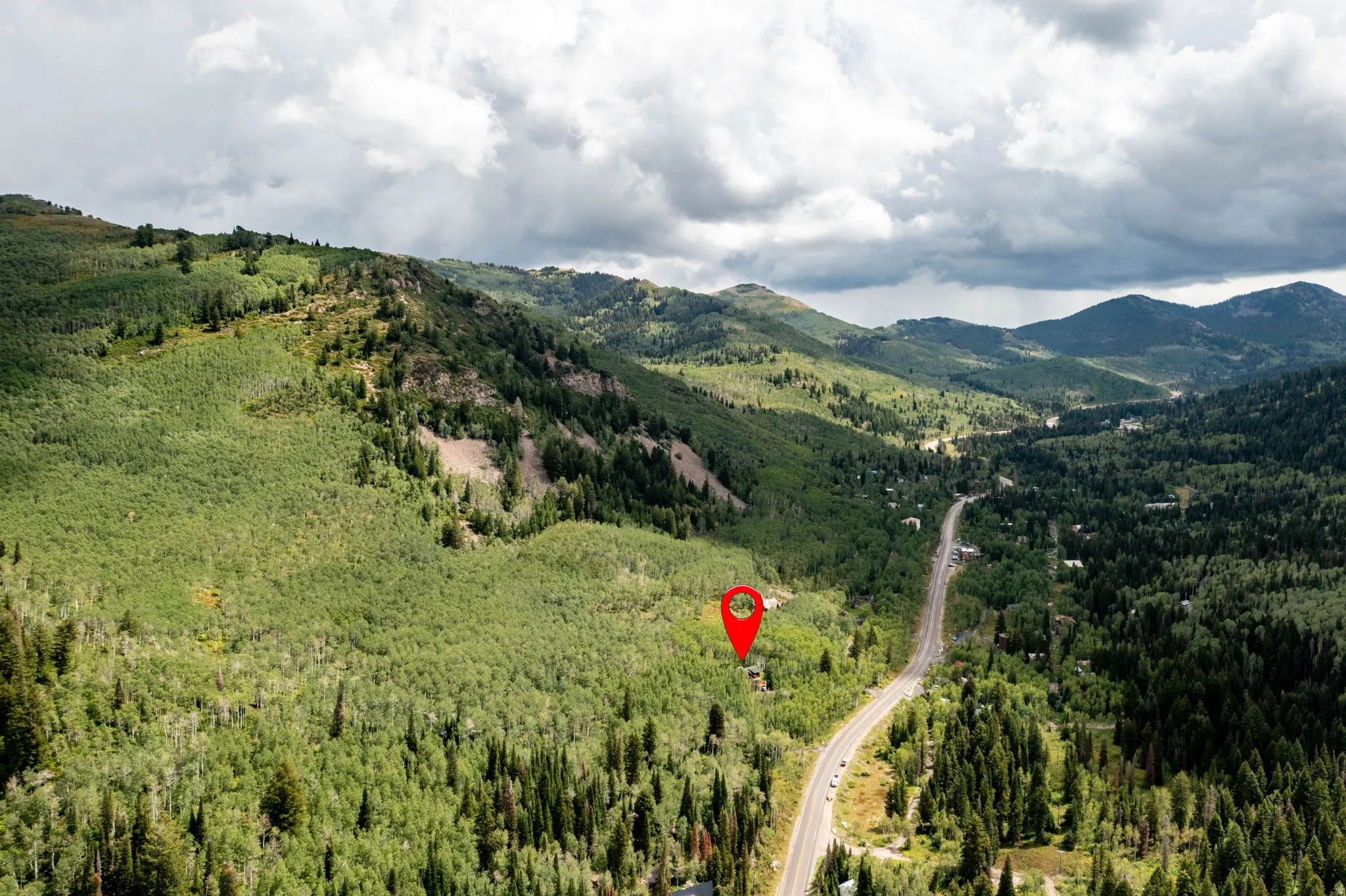 Expansive mountainous landscape with abundant evergreen and deciduous trees