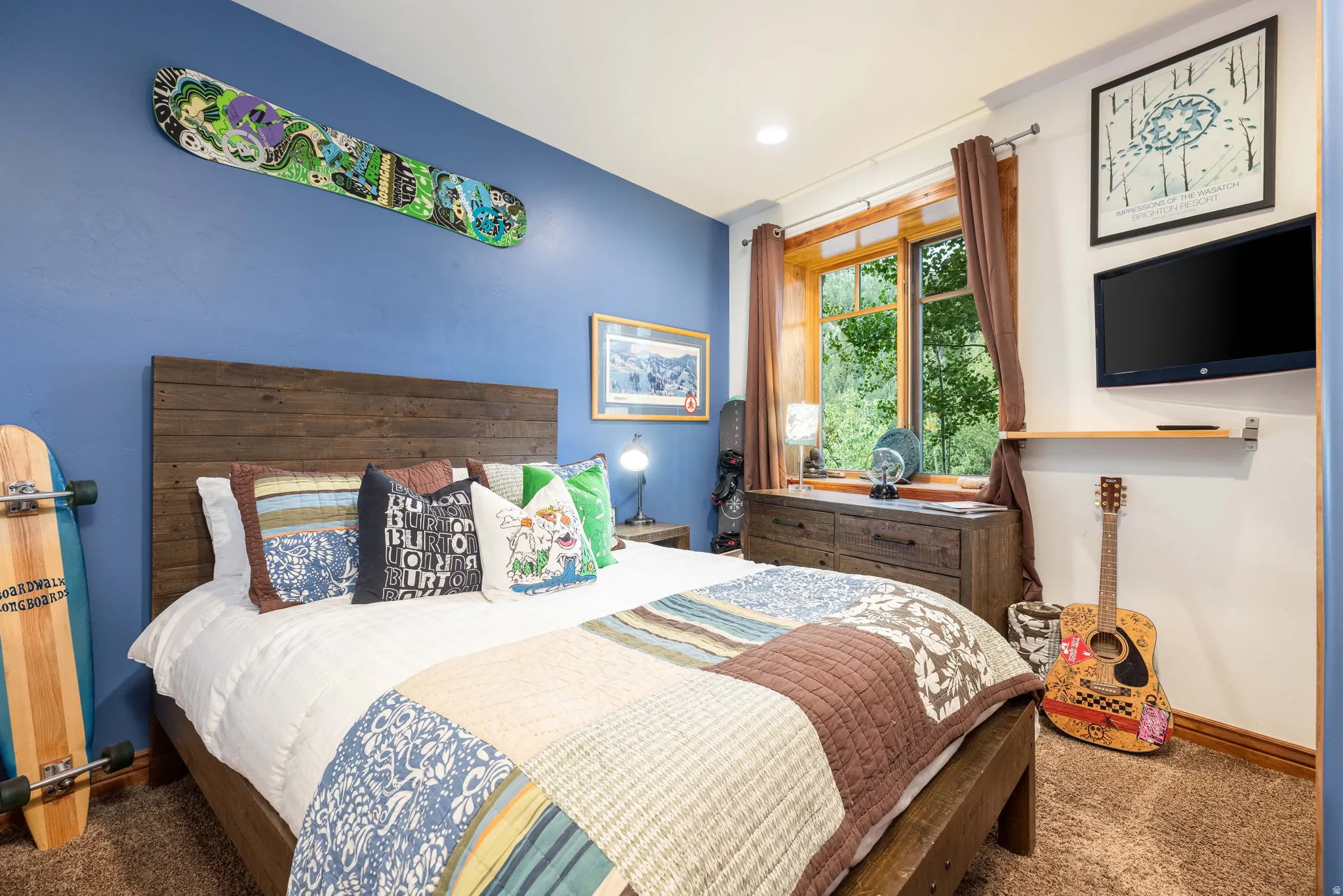 Bedroom featuring a wood-panel bed frame with a matching headboard and rustic dresser